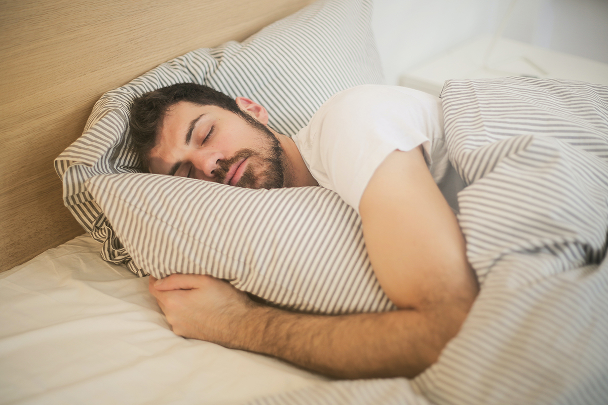 Man sleeping comfortably in bed