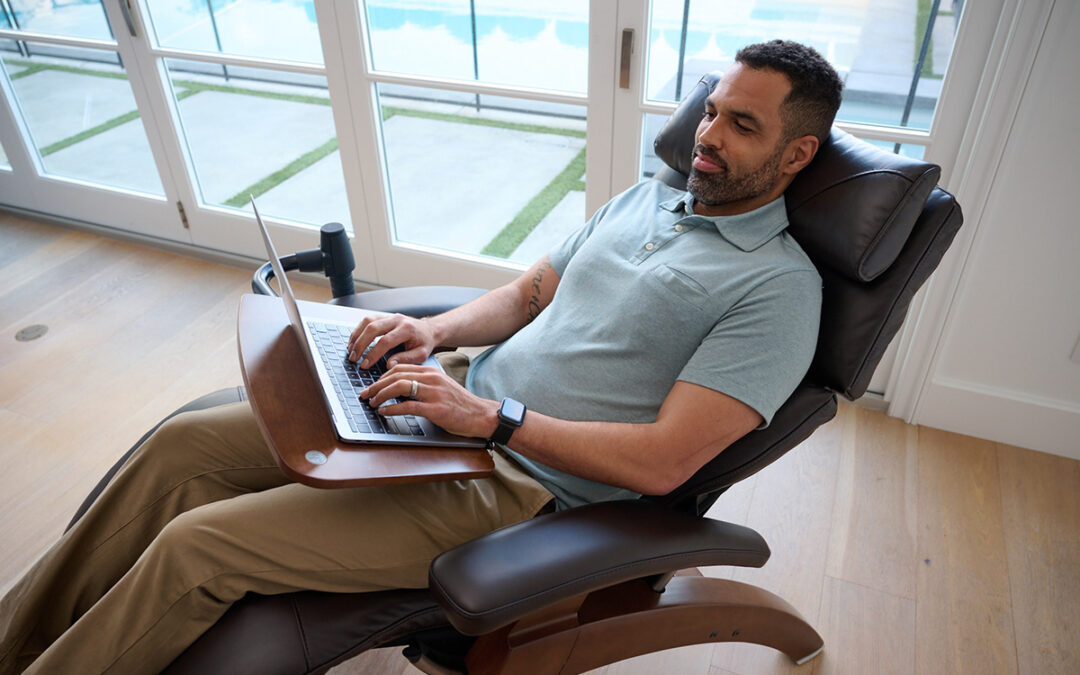 Man working on laptop in ergonomic chair