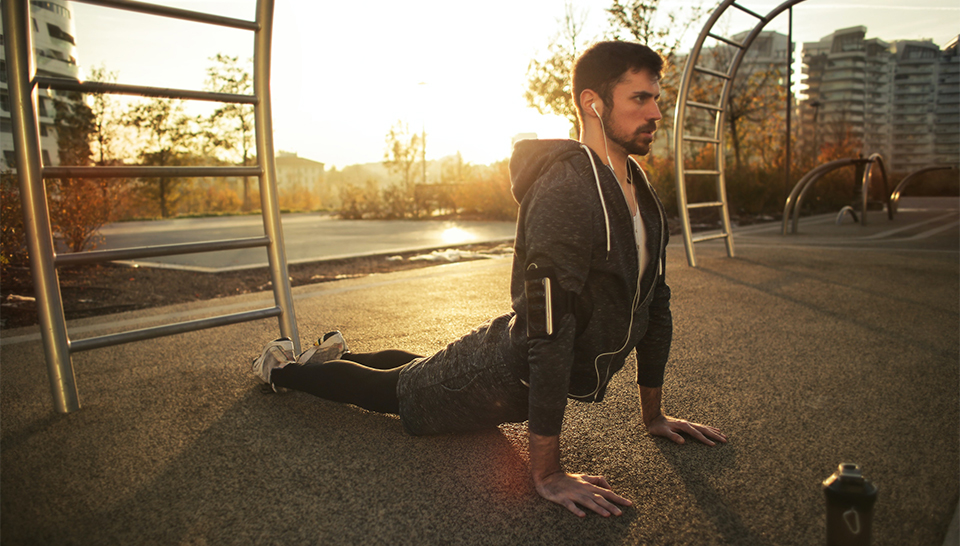 man stretching back outdoors